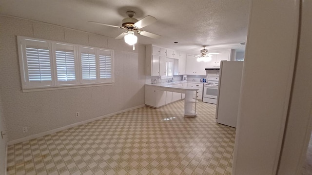 kitchen featuring sink, white appliances, ceiling fan, a textured ceiling, and white cabinets