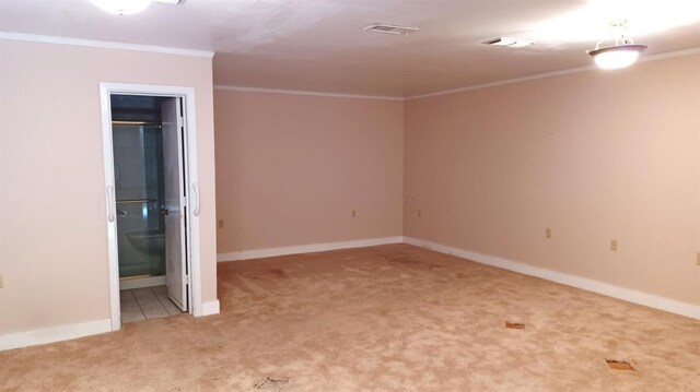 unfurnished room with ornamental molding and carpet flooring