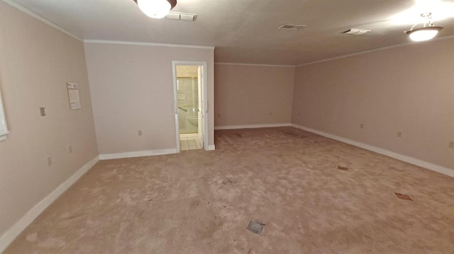 carpeted spare room featuring crown molding