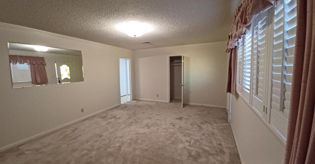 carpeted empty room featuring a textured ceiling