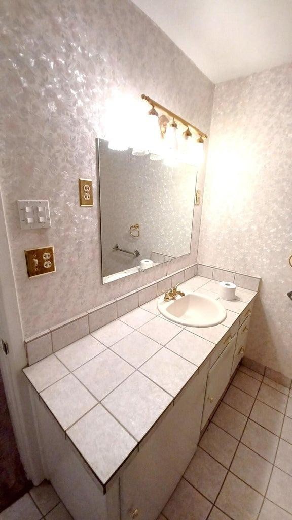 bathroom with tile patterned flooring and vanity