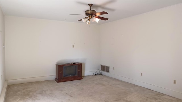 carpeted empty room featuring ceiling fan