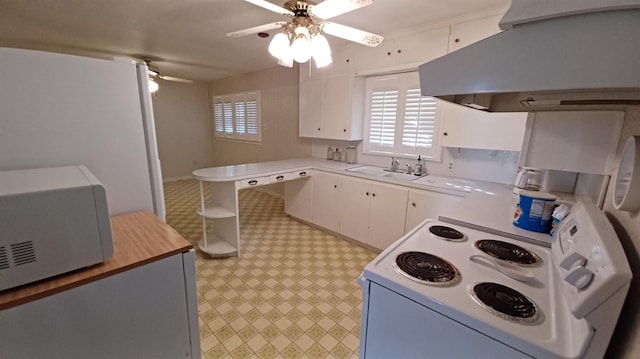 kitchen with sink, island exhaust hood, white cabinetry, ceiling fan, and white appliances