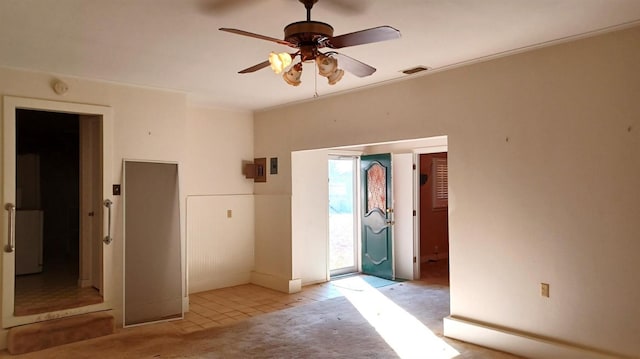 carpeted spare room featuring ornamental molding and ceiling fan