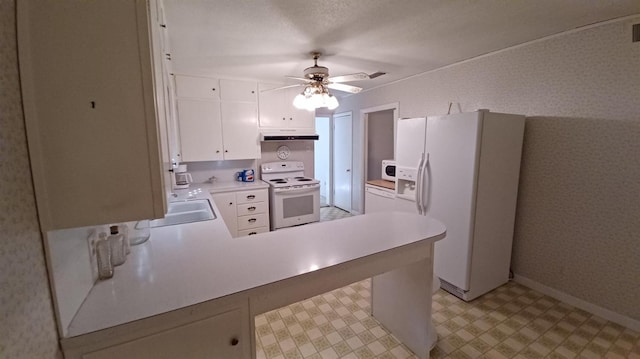 kitchen featuring a breakfast bar area, white appliances, kitchen peninsula, ceiling fan, and white cabinets