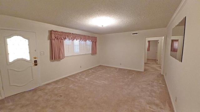 entrance foyer featuring crown molding, light carpet, and a textured ceiling