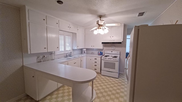 kitchen with white cabinetry, sink, white appliances, and kitchen peninsula