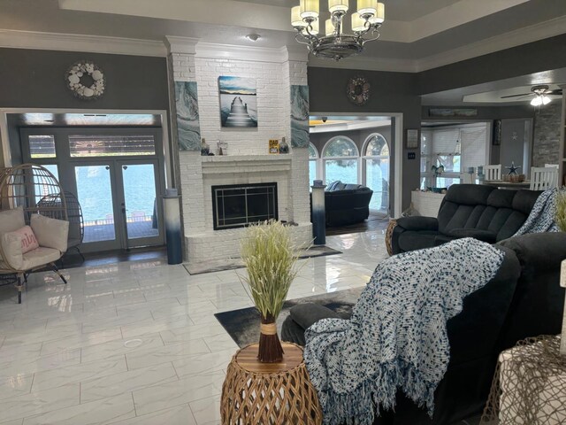 living room featuring a fireplace, ornamental molding, french doors, and a healthy amount of sunlight