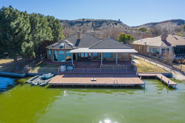 exterior space with a water and mountain view