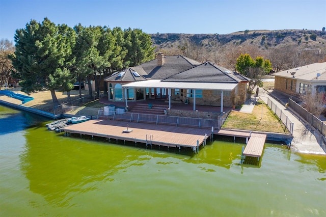 dock area with a patio and a water view