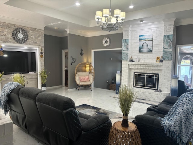 living room featuring an inviting chandelier, a brick fireplace, ornamental molding, and a raised ceiling