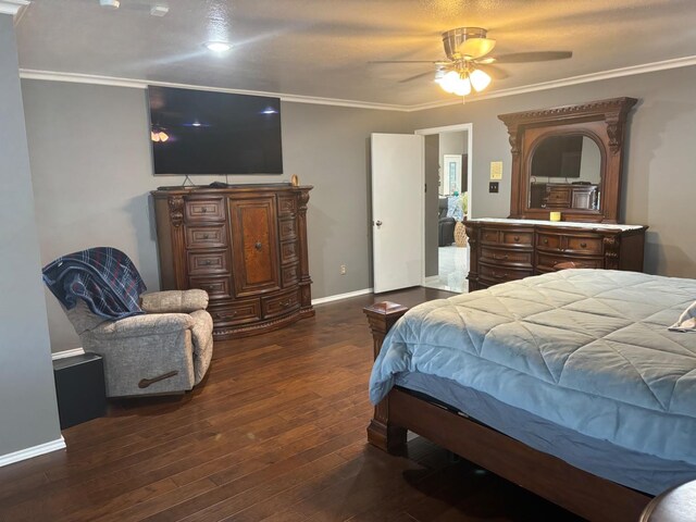 bedroom featuring dark hardwood / wood-style flooring, ornamental molding, and ceiling fan