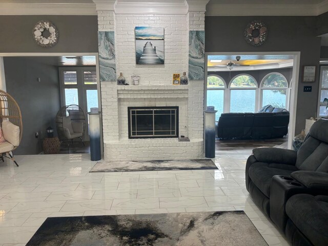 living room featuring crown molding, ceiling fan, and a brick fireplace