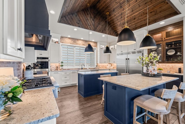 7733 46th St, Lubbock, TX 79407 - kitchen featuring appliances with stainless steel finishes, a center island, wood ceiling, high vaulted ceiling, and decorative backsplash