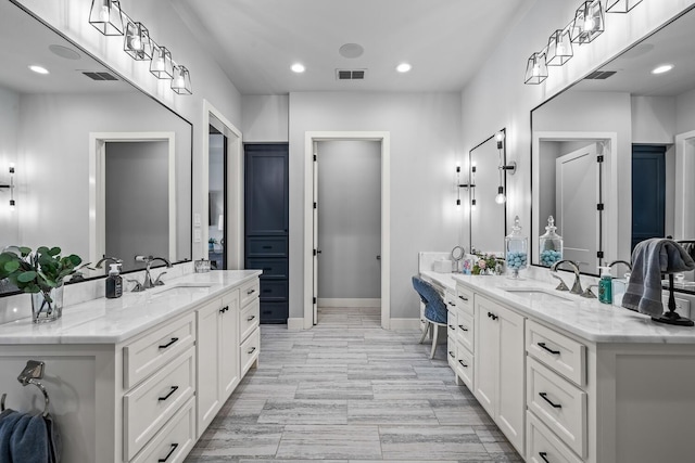 7733 46th St, Lubbock, TX 79407 - bathroom featuring two vanities and recessed lighting