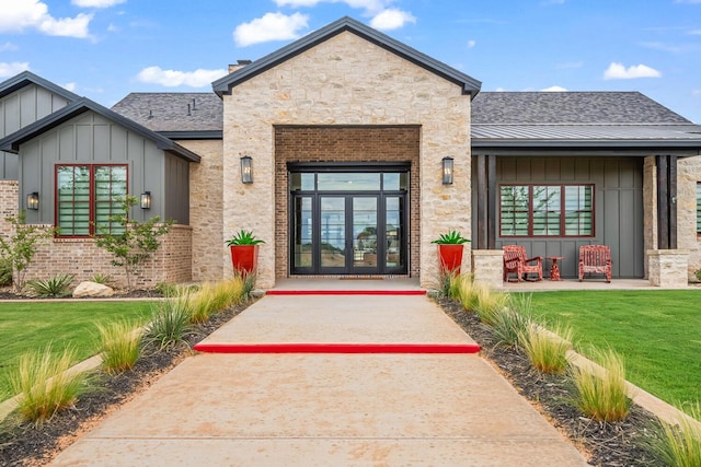 7733 46th St, Lubbock, TX 79407 - entrance to property with board and batten siding, a lawn, and stone siding