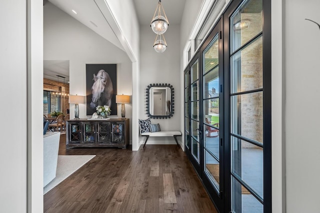 7733 46th St, Lubbock, TX 79407 - foyer with a high ceiling, dark wood-style flooring, healthy amount of natural light, a chandelier, and french doors