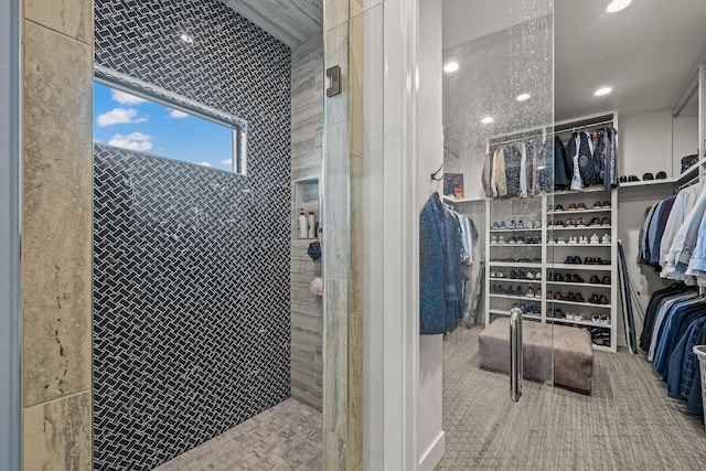 7733 46th St, Lubbock, TX 79407 - bathroom featuring a spacious closet, recessed lighting, and a tile shower