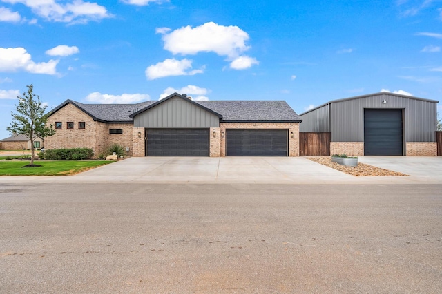 7733 46th St, Lubbock, TX 79407 - view of front of house featuring brick siding, driveway, and a garage