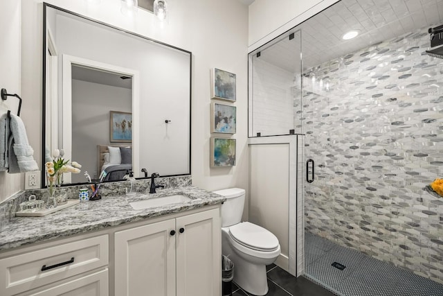 7733 46th St, Lubbock, TX 79407 - full bath featuring connected bathroom, vanity, a shower stall, and tile patterned flooring