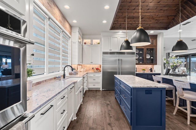 7733 46th St, Lubbock, TX 79407 - kitchen featuring blue cabinetry, stainless steel built in fridge, a center island, tasteful backsplash, and recessed lighting