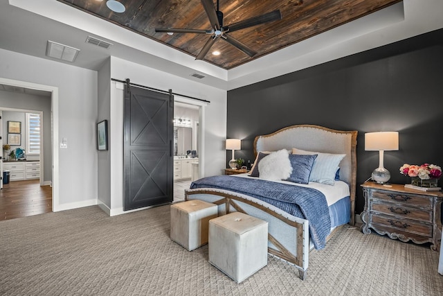 7733 46th St, Lubbock, TX 79407 - carpeted bedroom with a barn door, wooden ceiling, a raised ceiling, ensuite bath, and ceiling fan