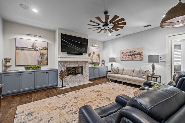 7733 46th St, Lubbock, TX 79407 - living area featuring dark wood-type flooring, a high end fireplace, recessed lighting, and a ceiling fan