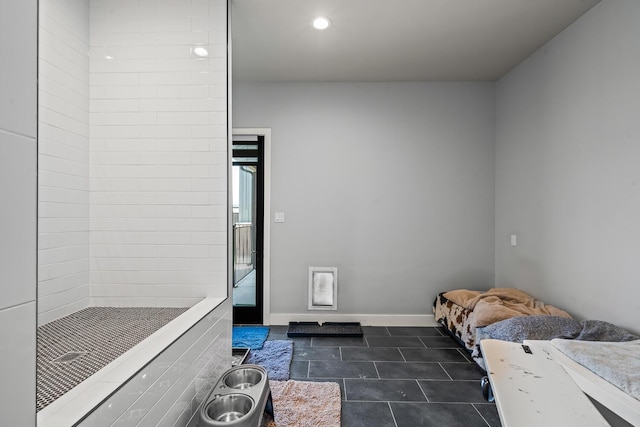 7733 46th St, Lubbock, TX 79407 - unfurnished bedroom with dark tile patterned floors and recessed lighting