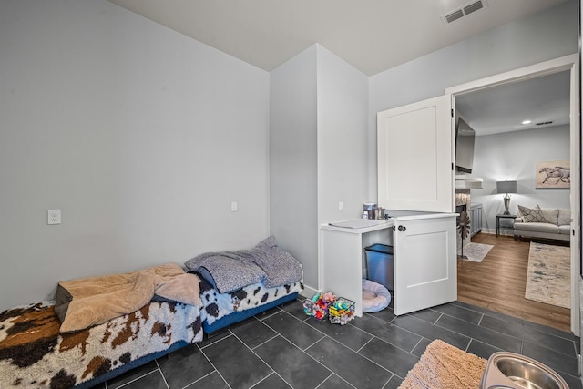 7733 46th St, Lubbock, TX 79407 - bedroom featuring dark tile patterned flooring and a fireplace
