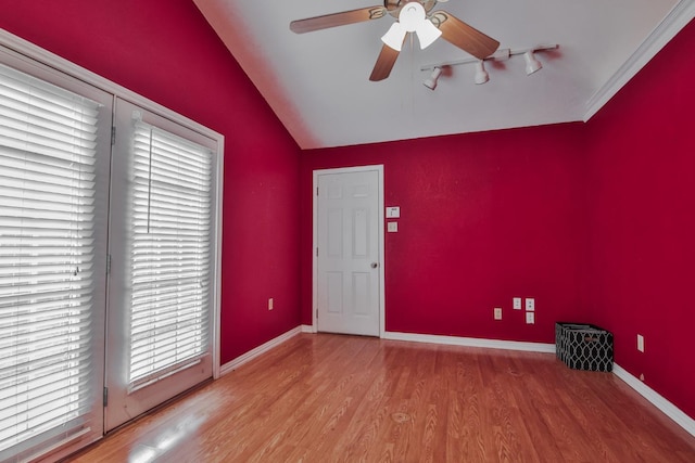 empty room with hardwood / wood-style flooring, ceiling fan, and lofted ceiling