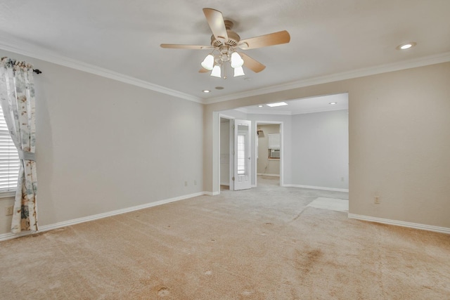 carpeted empty room featuring crown molding and ceiling fan