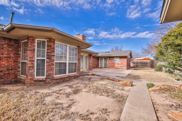 view of side of property with a patio