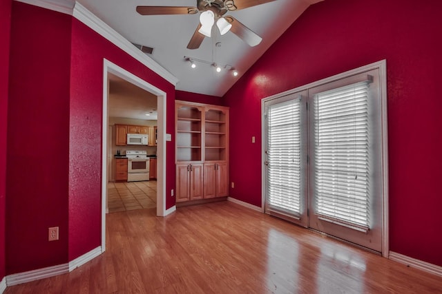 empty room featuring vaulted ceiling, ceiling fan, and light hardwood / wood-style floors