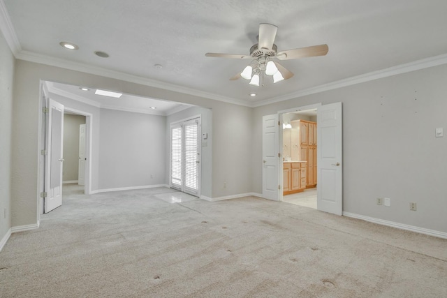 spare room featuring ceiling fan, ornamental molding, and light carpet