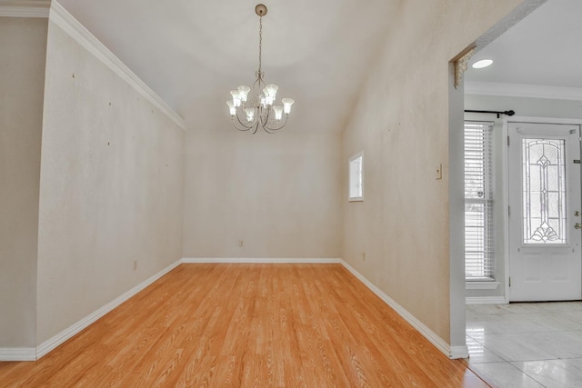 entrance foyer featuring crown molding, a healthy amount of sunlight, a chandelier, and wood-type flooring