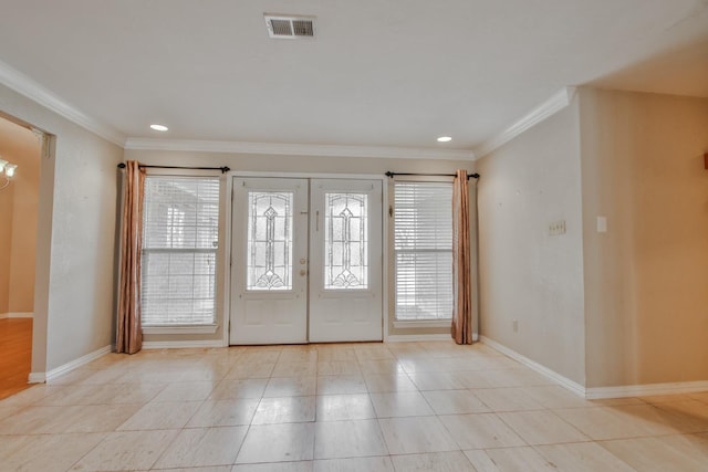 entrance foyer with french doors, crown molding, and light tile patterned floors