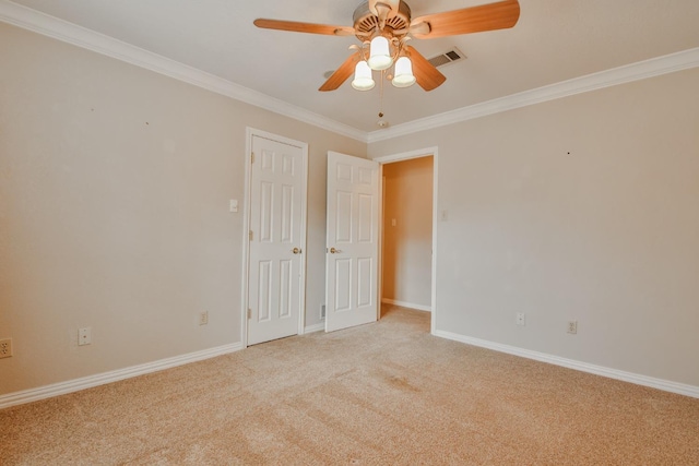 carpeted spare room with ornamental molding and ceiling fan