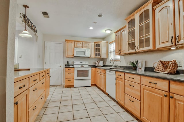 kitchen featuring light tile patterned flooring, pendant lighting, sink, light brown cabinets, and white appliances