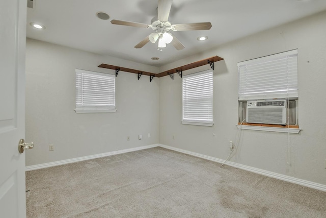 carpeted spare room featuring cooling unit and ceiling fan