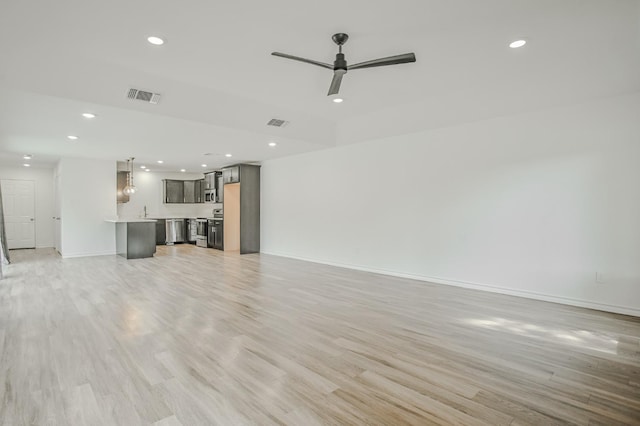 unfurnished living room with ceiling fan and light hardwood / wood-style floors