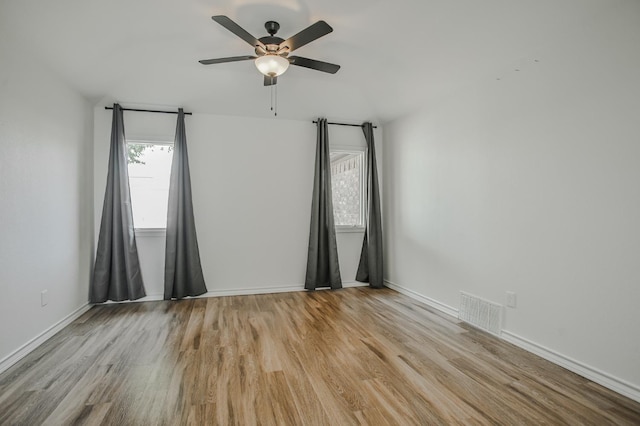 unfurnished room with ceiling fan and light wood-type flooring