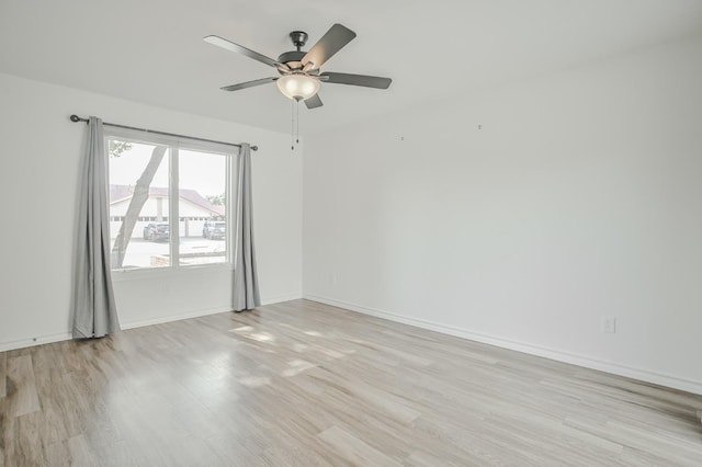 empty room with ceiling fan and light wood-type flooring