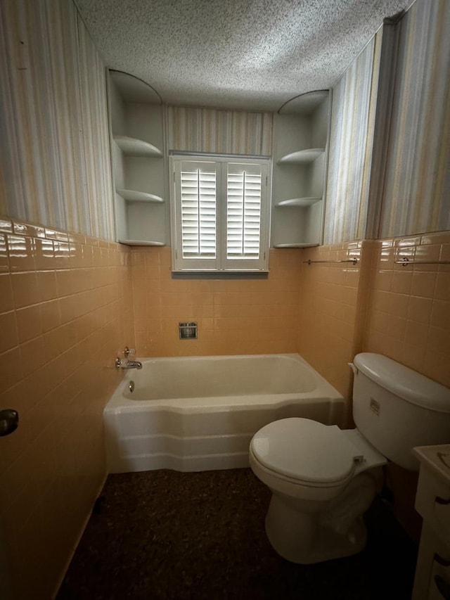 bathroom featuring tile walls, a textured ceiling, and toilet