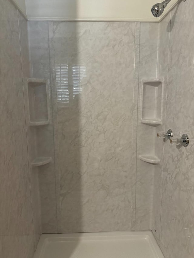 bathroom with a tile shower