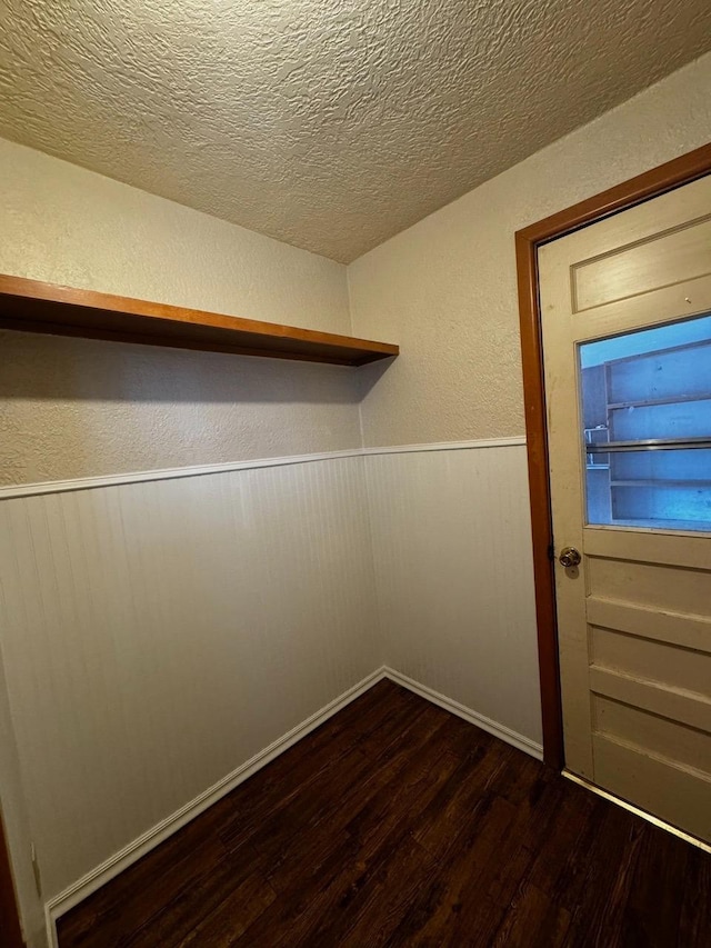 spacious closet featuring dark hardwood / wood-style flooring