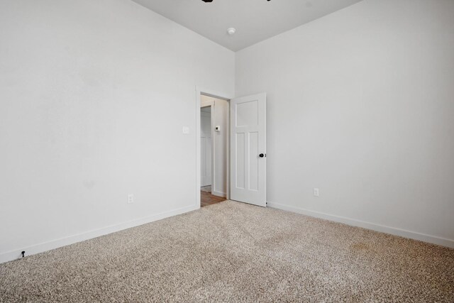 empty room featuring carpet and ceiling fan