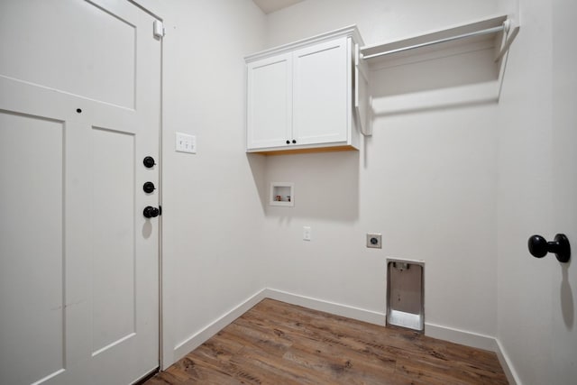 laundry room featuring dark wood-type flooring, cabinets, hookup for a washing machine, and electric dryer hookup