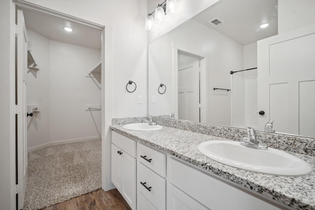 bathroom with vanity and wood-type flooring