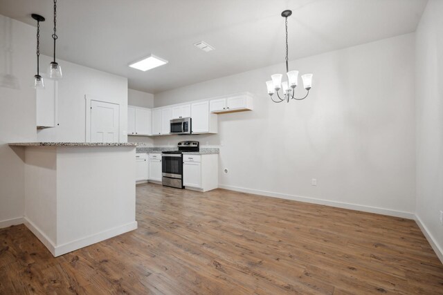 kitchen featuring white cabinetry, stainless steel appliances, decorative light fixtures, and wood-type flooring