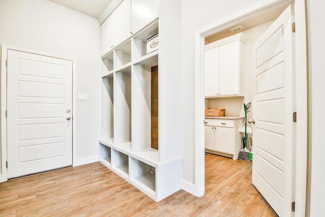 mudroom featuring light wood-type flooring and baseboards